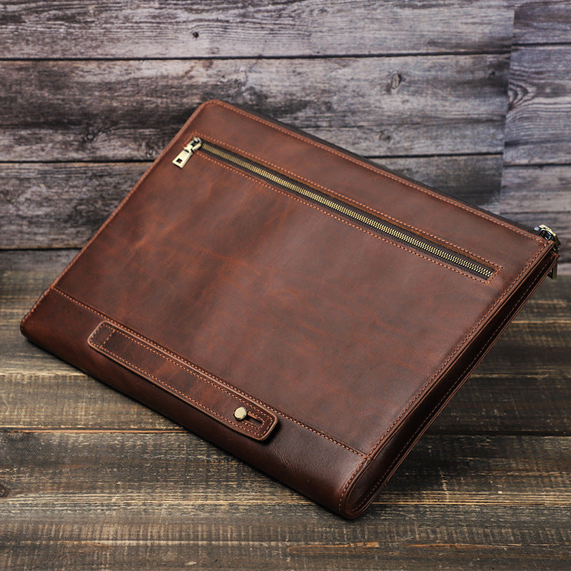 Brown leather briefcase on a wooden surface