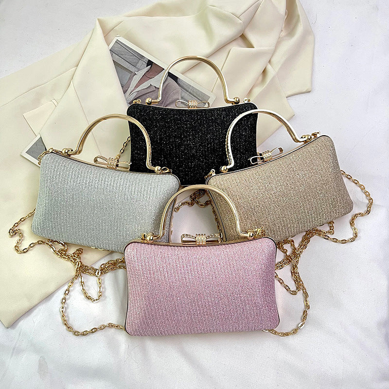 Four glittery handbags in different colors on a white background