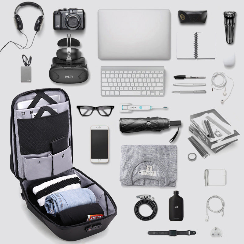 Collection of travel items including a backpack, laptop, camera, and various gadgets on a light gray background.