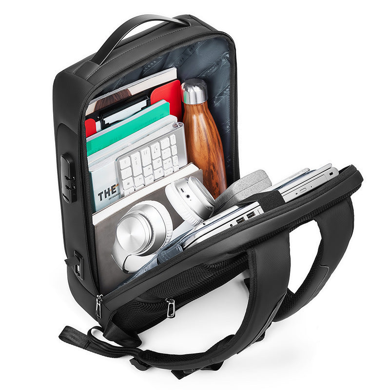 Black backpack with compartments containing a keyboard, bottle, and other items on a white background