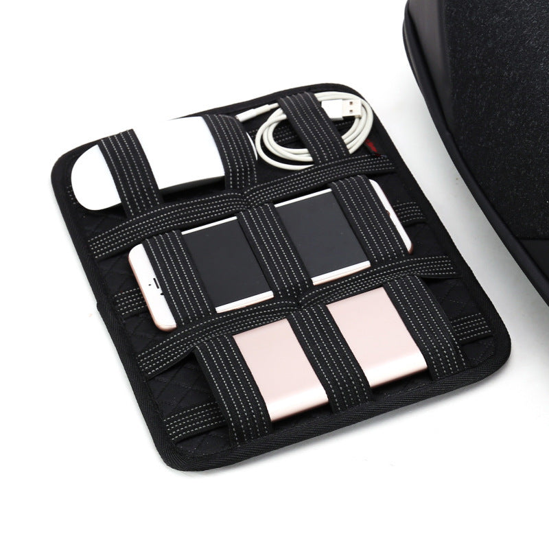 Black grid organizer with electronic devices on a white background