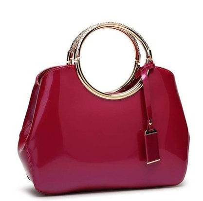 Red handbag with gold handle on a white background