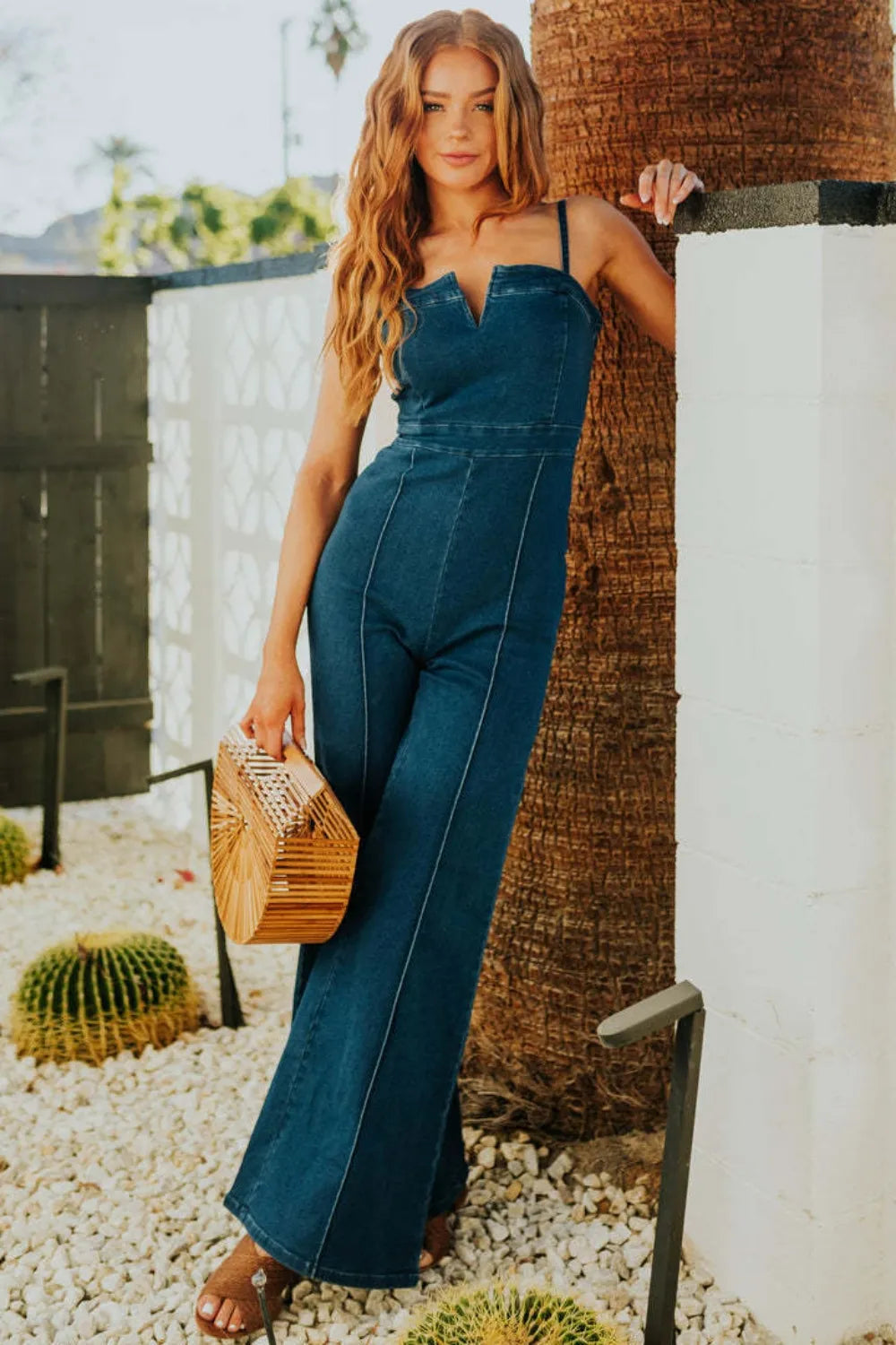 Model wearing Denim Dream jumpsuit with casual accessories