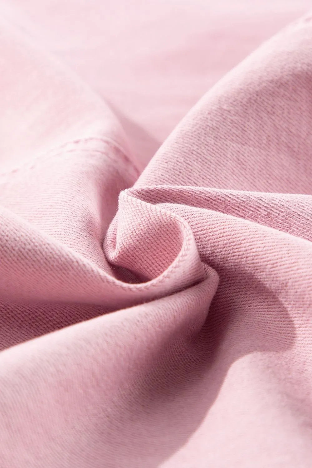 Light pink fabric with a soft swirl fold.